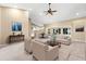 Bright open-concept living room with neutral finishes, fireplace, and views of the kitchen and backyard at 18736 Bent Pine Dr, Hudson, FL 34667