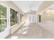 Sun-drenched sun room with large windows offering serene views of the outdoors at 18736 Bent Pine Dr, Hudson, FL 34667