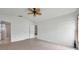 Neutral bedroom featuring tile floors, ceiling fan, and access to the ensuite bath at 2048 Ground Squirrel Dr, New Port Richey, FL 34655
