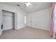Bedroom with tile floors, closet, fan, and access to an adjoining room at 2048 Ground Squirrel Dr, New Port Richey, FL 34655