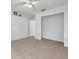 Bonus room with tile floors, shelving and view to a hallway at 2048 Ground Squirrel Dr, New Port Richey, FL 34655