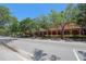 Exterior of a brick building lined with mature trees, offering a blend of classic architecture and natural beauty at 2048 Ground Squirrel Dr, New Port Richey, FL 34655