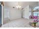 Bright dining area featuring tile floors, a chandelier, and a window for plenty of light at 2048 Ground Squirrel Dr, New Port Richey, FL 34655