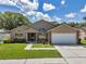 Charming single-story home boasts a manicured lawn, mature trees, and an attached two-car garage at 2048 Ground Squirrel Dr, New Port Richey, FL 34655