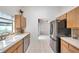 Kitchen featuring stainless steel appliances, bright natural lighting, and tile floors at 2048 Ground Squirrel Dr, New Port Richey, FL 34655