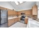 The kitchen offers wood cabinets, stainless appliances, tile backsplash, skylights, and tile floors at 2048 Ground Squirrel Dr, New Port Richey, FL 34655