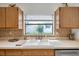 The kitchen sink sits beneath a window for natural light and a scenic view while doing dishes at 2048 Ground Squirrel Dr, New Port Richey, FL 34655