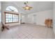 Spacious living room with tile floors, vaulted ceiling, and a large window for ample sunlight at 2048 Ground Squirrel Dr, New Port Richey, FL 34655