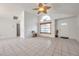 Inviting living room with high ceilings, tile floors, and a large window for natural light at 2048 Ground Squirrel Dr, New Port Richey, FL 34655
