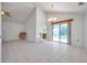 Open living space with tile floors, leading to the dining area and sliding glass doors to the backyard at 2048 Ground Squirrel Dr, New Port Richey, FL 34655