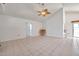 Bright living room featuring tile floors, neutral walls, and a door leading to other areas of the home at 2048 Ground Squirrel Dr, New Port Richey, FL 34655