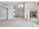 Bright living room showcasing tile floors, chandelier lighting, and open floor plan concept to kitchen at 2048 Ground Squirrel Dr, New Port Richey, FL 34655