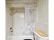 Bathroom featuring a shower-tub combo with a fish-themed curtain and tile surround at 2101 Sunset Point Rd # 201, Clearwater, FL 33765