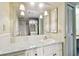 Bathroom featuring a vanity with a large mirror and ample lighting at 2101 Sunset Point Rd # 201, Clearwater, FL 33765