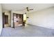 Bedroom with desk and shelving, adjacent to bathroom at 2101 Sunset Point Rd # 201, Clearwater, FL 33765