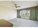 Simple bedroom with ceiling fan and medium sized window at 2101 Sunset Point Rd # 201, Clearwater, FL 33765