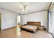 Spacious bedroom with light wood floors and a large glass door to a screened porch at 2101 Sunset Point Rd # 201, Clearwater, FL 33765