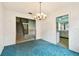 Dining room features a vintage chandelier and is adjacent to the stairs and kitchen at 2101 Sunset Point Rd # 201, Clearwater, FL 33765