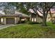 Charming single-Gathering home featuring a two-car garage, well-maintained lawn, and mature trees at 2101 Sunset Point Rd # 201, Clearwater, FL 33765