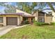 Charming townhome with a well-maintained front yard and stone accents on the facade at 2101 Sunset Point Rd # 201, Clearwater, FL 33765