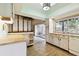 Traditional kitchen with wood floor and view to screened patio at 2101 Sunset Point Rd # 201, Clearwater, FL 33765