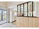 The bright kitchen features white appliances and tile floors and offers access to screened in porch at 2101 Sunset Point Rd # 201, Clearwater, FL 33765