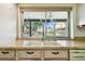 Kitchen with a double sink and a view of the backyard at 2101 Sunset Point Rd # 201, Clearwater, FL 33765