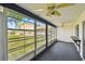 Enclosed lanai with ceiling fans and a screen wall with view of the backyard at 2101 Sunset Point Rd # 201, Clearwater, FL 33765