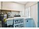 Laundry room with both washer and dryer, as well as a utility sink at 2101 Sunset Point Rd # 201, Clearwater, FL 33765