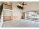 Open living room featuring high ceilings, and adjacent sun room at 2101 Sunset Point Rd # 201, Clearwater, FL 33765