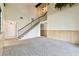 Spacious living room with staircase and carpet at 2101 Sunset Point Rd # 201, Clearwater, FL 33765