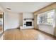 Bright living room with tile flooring and a white-painted brick fireplace at 2101 Sunset Point Rd # 201, Clearwater, FL 33765