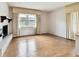 Spacious living room with tile floors and a classic brick fireplace at 2101 Sunset Point Rd # 201, Clearwater, FL 33765