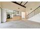 Open living room with view of kitchen and staircase at 2101 Sunset Point Rd # 201, Clearwater, FL 33765