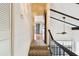 Carpeted stairway featuring railing and a view through to an upper floor at 2101 Sunset Point Rd # 201, Clearwater, FL 33765