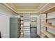 Organized storage room featuring shelving units and secure safe at 2101 Sunset Point Rd # 201, Clearwater, FL 33765
