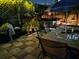 Outdoor dining area featuring a hot tub, dining table, and decorative lighting for evening enjoyment at 21045 Lazy Days Cir, Lutz, FL 33558