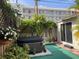 Private fenced backyard featuring a hot tub, patio, lush greenery, and an ideal space for relaxation at 21045 Lazy Days Cir, Lutz, FL 33558