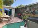 Outdoor patio area featuring a grill, dining set, and hot tub, ideal for relaxation and entertaining in a private space at 21045 Lazy Days Cir, Lutz, FL 33558