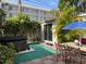 Backyard with a hot tub and dining area, perfect for outdoor entertaining and relaxation at 21045 Lazy Days Cir, Lutz, FL 33558