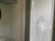 Bathroom featuring a decorative frosted glass shower door and white walls, offering a clean and private space at 21045 Lazy Days Cir, Lutz, FL 33558