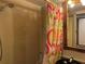 Cozy bathroom showcasing a patterned shower curtain, tiled walls, and classic fixtures for a comfortable experience at 21045 Lazy Days Cir, Lutz, FL 33558