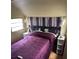 View of cozy bedroom with purple comforter at 21045 Lazy Days Cir, Lutz, FL 33558
