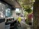 Exterior view of pathway with plants, showing a bike, seating, and the home's design within its natural landscape at 21045 Lazy Days Cir, Lutz, FL 33558