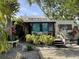 Charming single story home with a small porch and lush landscaping creating a private and inviting entrance at 21045 Lazy Days Cir, Lutz, FL 33558
