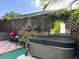 A covered hot tub is surrounded by flowers and greenery at 21045 Lazy Days Cir, Lutz, FL 33558