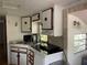 Functional kitchen with white cabinets, black countertops, and a sink area for easy meal preparation at 21045 Lazy Days Cir, Lutz, FL 33558