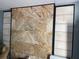 Living room accent wall in stone and black framing creates a chic and stylish architectural feature at 21045 Lazy Days Cir, Lutz, FL 33558