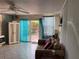 Cozy living room features a sliding glass door to the backyard, tile flooring, and peaceful, relaxing space at 21045 Lazy Days Cir, Lutz, FL 33558