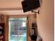 Cozy living room featuring a sliding door leading to the backyard and mounted TV at 21045 Lazy Days Cir, Lutz, FL 33558